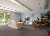 Thumbnail 17 of 21 - a living room and dining room with a couch and a table
