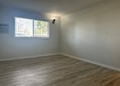 Thumbnail 2 of 10 - A room with a window and a light on the wall.