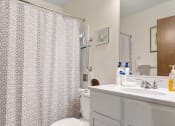 Thumbnail 18 of 23 - a bathroom with a shower and a toilet and a sink