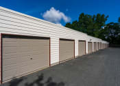 Thumbnail 17 of 18 - a row of garage doors on the side of a building