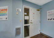 Thumbnail 13 of 18 - a room with a white door and a sign on the wall