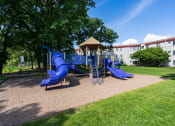Thumbnail 10 of 18 - a playground with blue slides and a gazebo