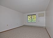 Thumbnail 4 of 7 - A room with a window and a carpeted floor.