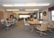 Thumbnail 6 of 7 - A conference room with a long table and chairs.