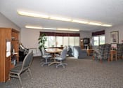 Thumbnail 7 of 7 - A conference room with a table, chairs, and a television.
