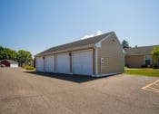 Thumbnail 19 of 19 - a small garage with white doors on the side of a road