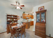 Thumbnail 13 of 19 - a dining room with a table and chairs and a kitchen