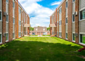 Thumbnail 5 of 28 - a view of a courtyard in front of a brick building