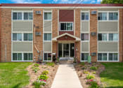 Thumbnail 6 of 28 - an apartment building with a sidewalk in front of it