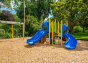 Thumbnail 27 of 28 - a playground with slides and a picnic table