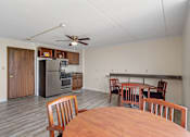 Thumbnail 29 of 29 - a dining room and kitchen with a wooden table and chairs