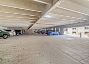 Thumbnail 6 of 29 - a parking garage with cars parked in it