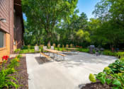 Thumbnail 5 of 18 - a patio with benches and tables in front of a building