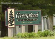 Thumbnail 1 of 6 - a sign in front of a building