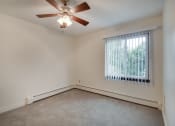 Thumbnail 9 of 13 - an empty living room with a ceiling fan and a window