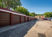 Thumbnail 13 of 13 - a row of garages with cars parked in front of them