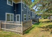 Thumbnail 4 of 6 - a wooden fence in front of a blue house