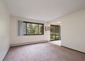 Thumbnail 11 of 19 - an empty living room with a large window and a door to a yard