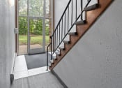 Thumbnail 9 of 20 - a staircase in a house with a glass door