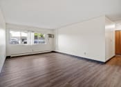 Thumbnail 15 of 20 - an empty living room with white walls and wood floors
