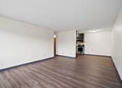 Thumbnail 14 of 20 - an empty living room with white walls and wood flooring