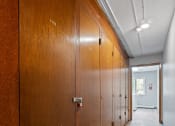 Thumbnail 19 of 20 - a row of wooden lockers in a hallway of a building