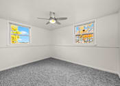 Thumbnail 6 of 10 - A room with a ceiling fan and two windows.