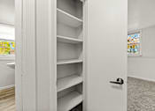 Thumbnail 8 of 10 - A white closet with shelves and a door.