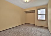 Thumbnail 7 of 7 - A room with a carpeted floor and a window.