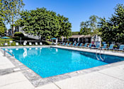 Thumbnail 63 of 80 - A large swimming pool surrounded by trees and lounge chairs.at Addison at Sutherland, Knoxville, TN 37909  