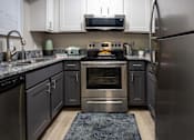 Thumbnail 6 of 80 - A modern kitchen with a stainless steel refrigerator and oven.at Addison at Sutherland, Knoxville, TN  