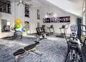 Thumbnail 67 of 80 - A gym with exercise equipment and a fan.at Addison at Sutherland, Knoxville, TN 37909  
