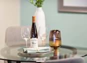 Thumbnail 11 of 80 - A bottle of wine and a glass are on a table.at Addison at Sutherland, Knoxville  