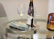 Thumbnail 13 of 80 - A bottle of wine is on a table with two glasses and a plate with two napkins.at Addison at Sutherland, Tennessee  