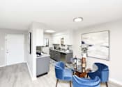 Thumbnail 14 of 80 - A modern kitchen with a dining table and blue chairs.at Addison at Sutherland, Knoxville, TN  