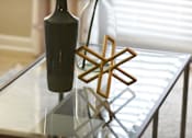 Thumbnail 20 of 80 - A bottle of wine and a wooden star-shaped object on a glass table.at Addison at Sutherland, Tennessee, 37909