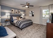 Thumbnail 48 of 80 - A bedroom with a bed, a ceiling fan, and a nightstand.at Addison at Sutherland, Knoxville, TN  