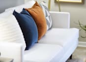 Thumbnail 50 of 80 - A white couch with three pillows on it.at Addison at Sutherland, Knoxville, TN 37909  