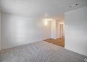 Thumbnail 14 of 15 - A room with white walls and a carpeted floor.