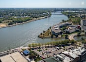 Thumbnail 13 of 34 - an aerial view of a parking lot next to a river