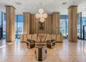 Thumbnail 16 of 34 - a lobby with chairs and a table and a tower hotel sign