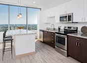 Thumbnail 3 of 34 - a kitchen with a island and stainless steel appliances