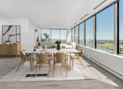 Thumbnail 6 of 34 - a dining room with a white table and chairs and large windows