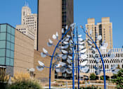 Thumbnail 32 of 34 - a sculpture of birds in front of a tall building