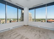 Thumbnail 10 of 34 - an empty living room with a view of the city