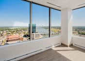 Thumbnail 8 of 34 - a view of a city from a room with large windows