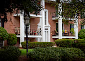 Thumbnail 6 of 10 - A white building with a black lamp post in front of it.
