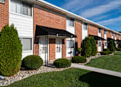 Thumbnail 1 of 16 - A row of houses with a white and red brick facade.