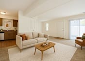 Thumbnail 3 of 20 - A living room with a couch, a coffee table, and a chair.