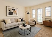 Thumbnail 6 of 16 - A living room with a grey couch, a black floor lamp, and a framed picture on the wall.